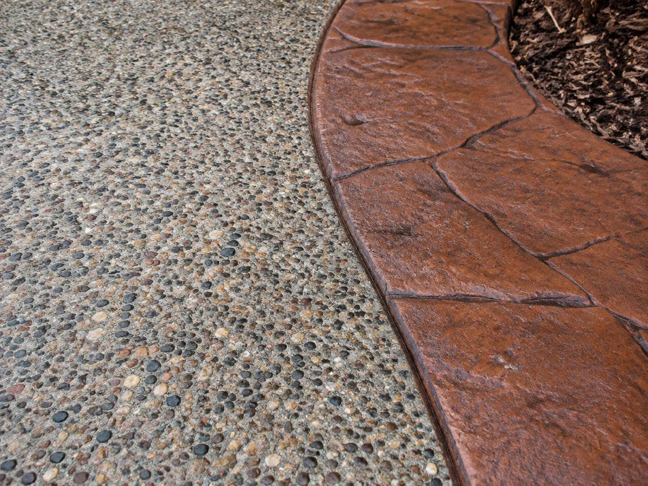 Exposed aggregate concrete with a colored stamped border